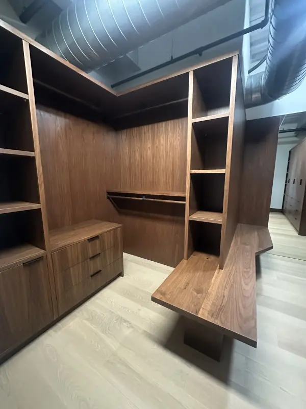 Built-in walnut closet with open hanging and drawers