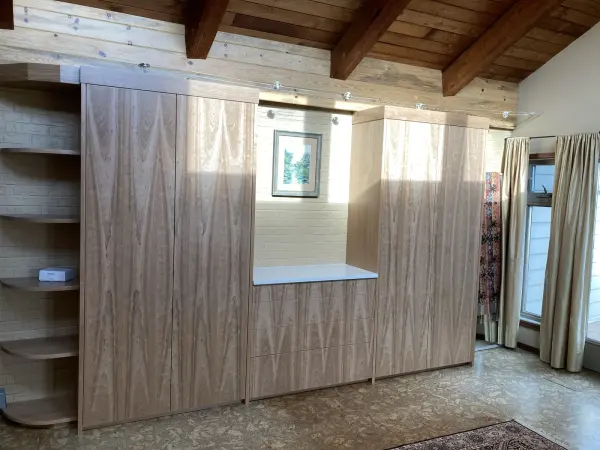 Built-in wardrobe wall under an exposed beam ceiling