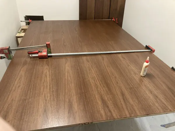 A large walnut panel clamped for glue-up in the shop, on its way to becoming a kitchen piece