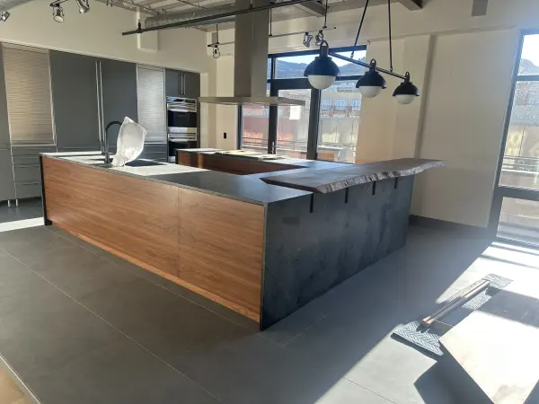 Walnut flat panel custom kitchen cabinets with stone countertops