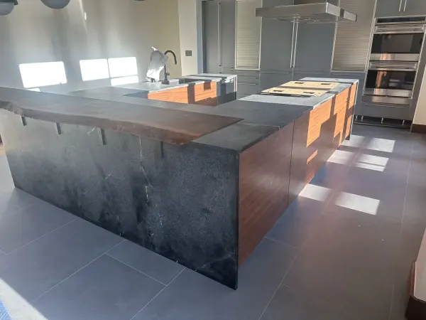 Walnut flat panel kitchen seen from the dining side