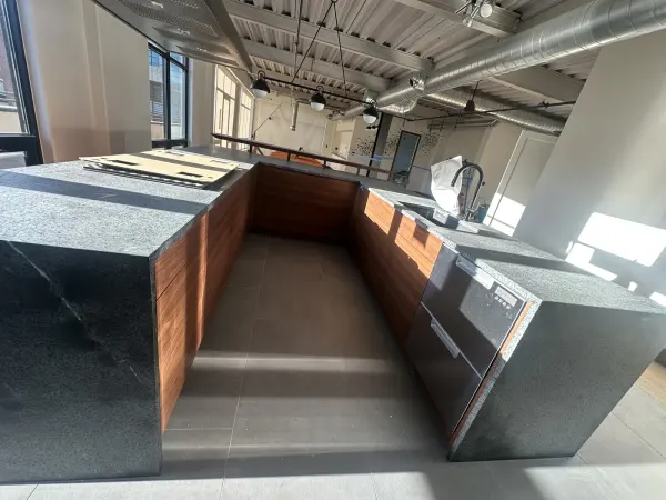 Walnut flat panel kitchen with an island and bar seating